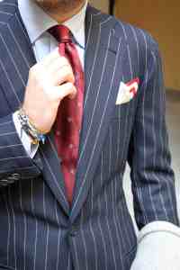 Luca-Rubinacci-pin-stripe-suit-red-tie-wrist-style